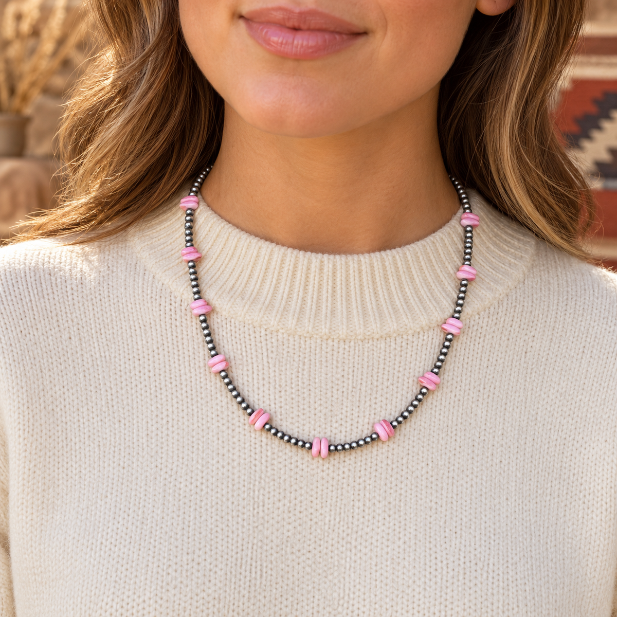Silver Desert Pearls & Pink Conch Chips Necklace worn over a cream crew-neck top.