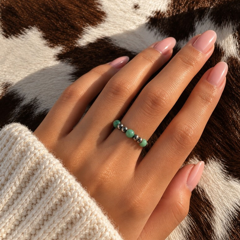 Green turquoise Desert Pearl stretch ring worn on a finger