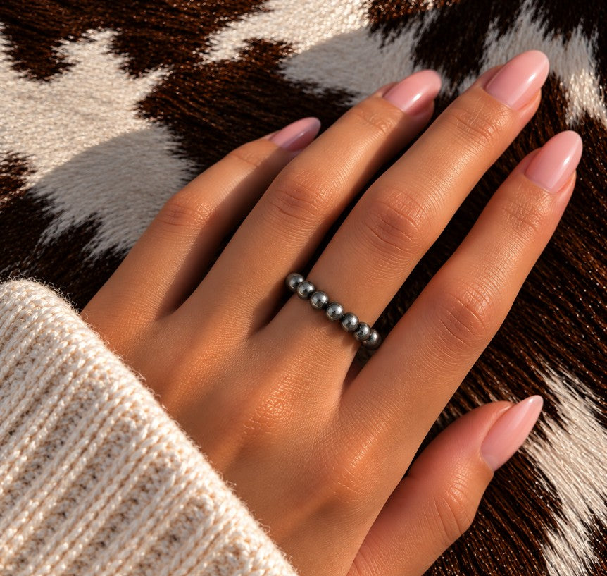 All silver Desert Pearl stretch ring worn on a finger