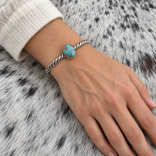 Elaine Tahe Navajo Artist Turquoise and Silver Twisted Wire Bracelet worn on an adult model's wrist