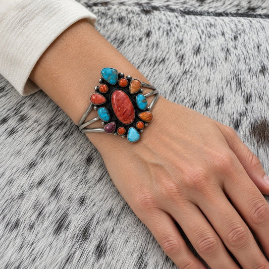 Multi Stone Turquoise and Spiny Oyster Cluster Bracelet worn on an adult model's wrist