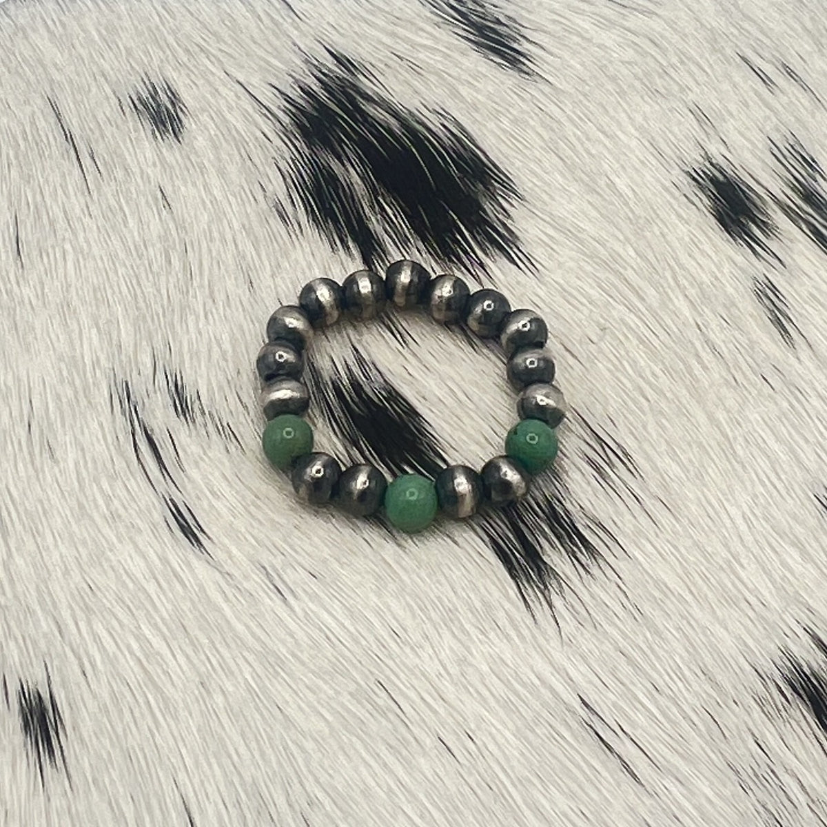 Another view of the green turquoise and silver bead stretch ring on cowhide