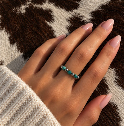 Blue turquoise Desert Pearl stretch ring worn on a finger