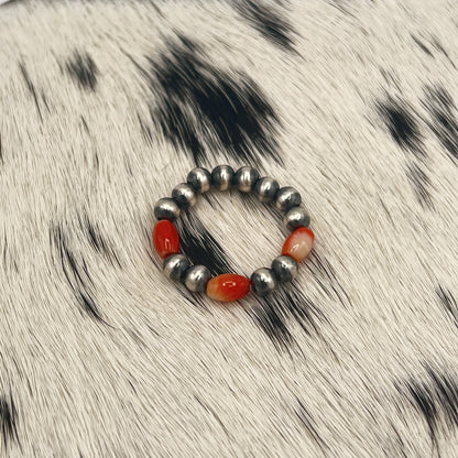 Another view of the spiny oyster and silver bead stretch ring on cowhide