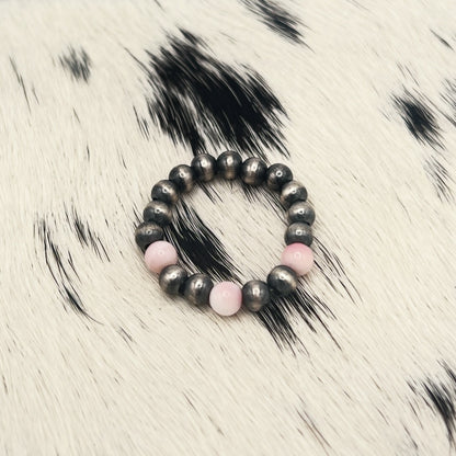 Another view of the pink conch and silver bead stretch ring on cowhide