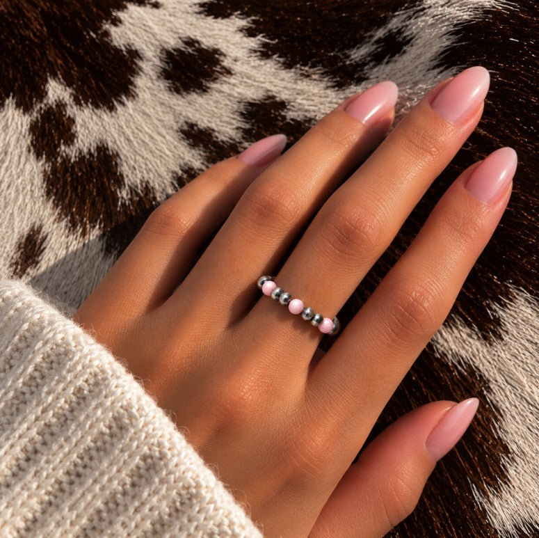 Pink Desert Pearl stretch ring worn on a finger
