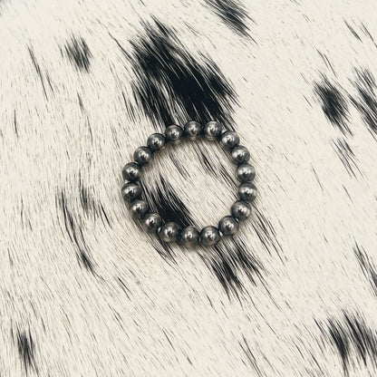 Another view of the all silver Desert Pearl bead stretch ring on cowhide