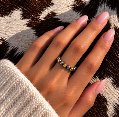 Gold filled and silver Desert Pearl stretch ring worn on a finger