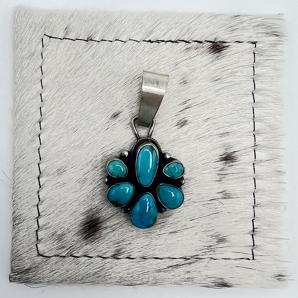 Front view of Sheila Becenti 6-stone Sonoran turquoise cluster pendant with wide silver bail