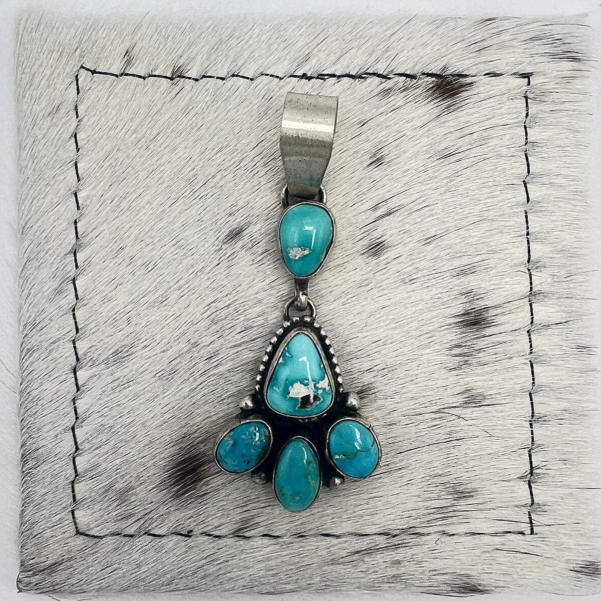 Front view of Betty Tom Blue Bird turquoise drop pendant with wide silver bail