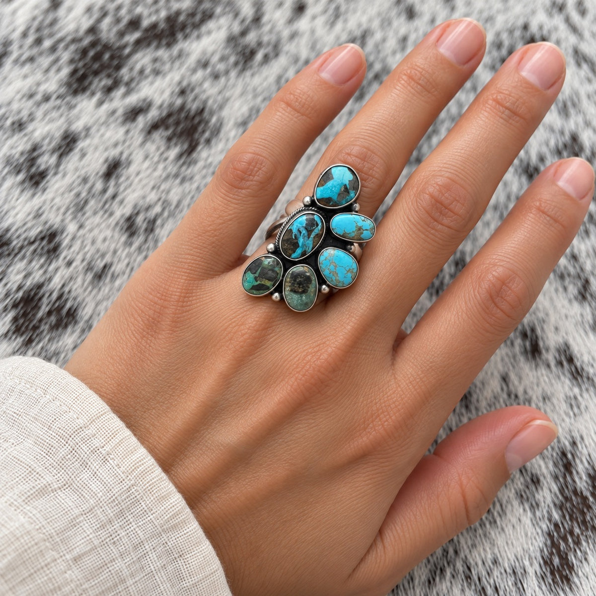 Blue Moon Turquoise Half Cluster Ring worn around a finger; approximate scale