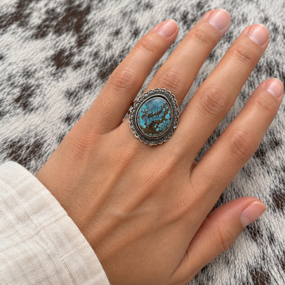 Blue Moon Turquoise Ring by Cordell Platero worn around a finger; approximate scale