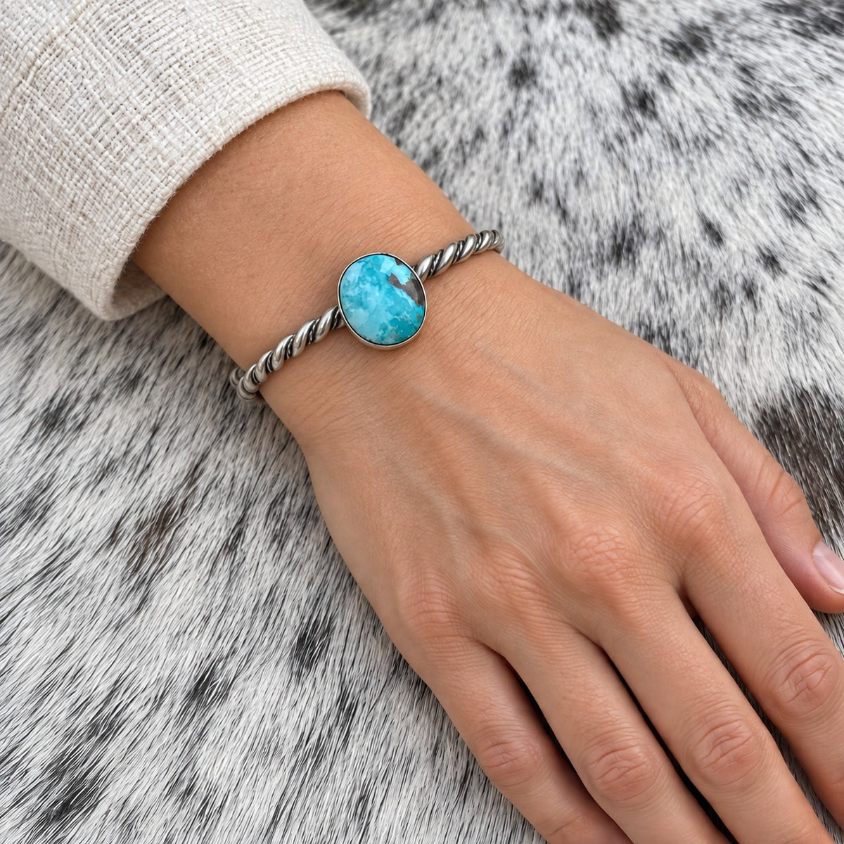Elaine Tahe Navajo Artist Turquoise Bracelets in Sterling Silver worn on an adult model's wrist