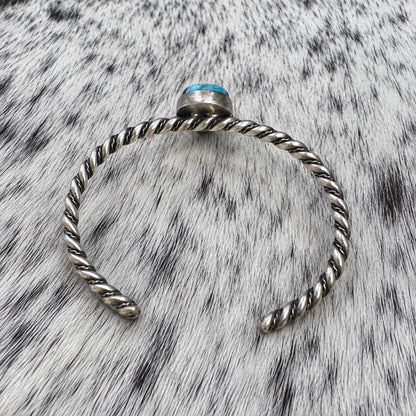 Elaine Tahe Navajo Artist Turquoise Bracelets in Sterling Silver — additional catalog view on gray-and-white cowhide