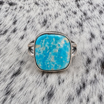 Freeform Turquoise Ring by Sheila Tso — front view on gray-and-white cowhide