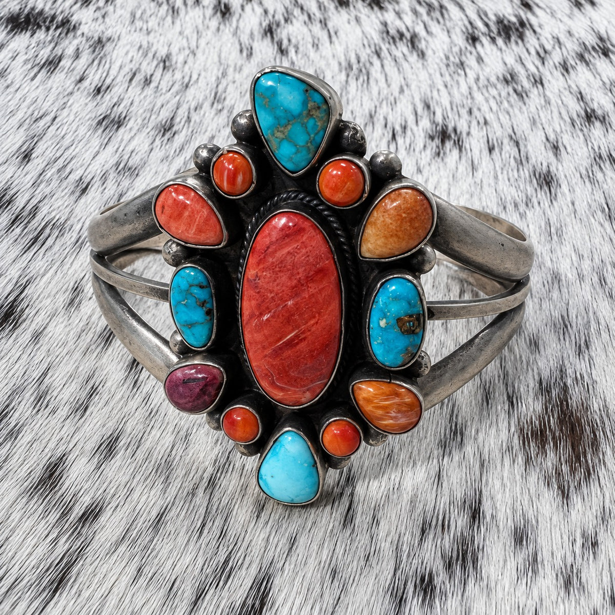 Multi Stone Turquoise and Spiny Oyster Cluster Bracelet on gray-and-white cowhide