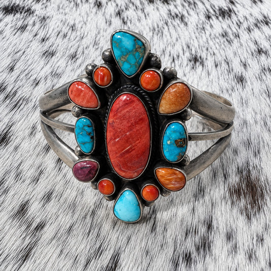Multi Stone Turquoise and Spiny Oyster Cluster Bracelet on gray-and-white cowhide